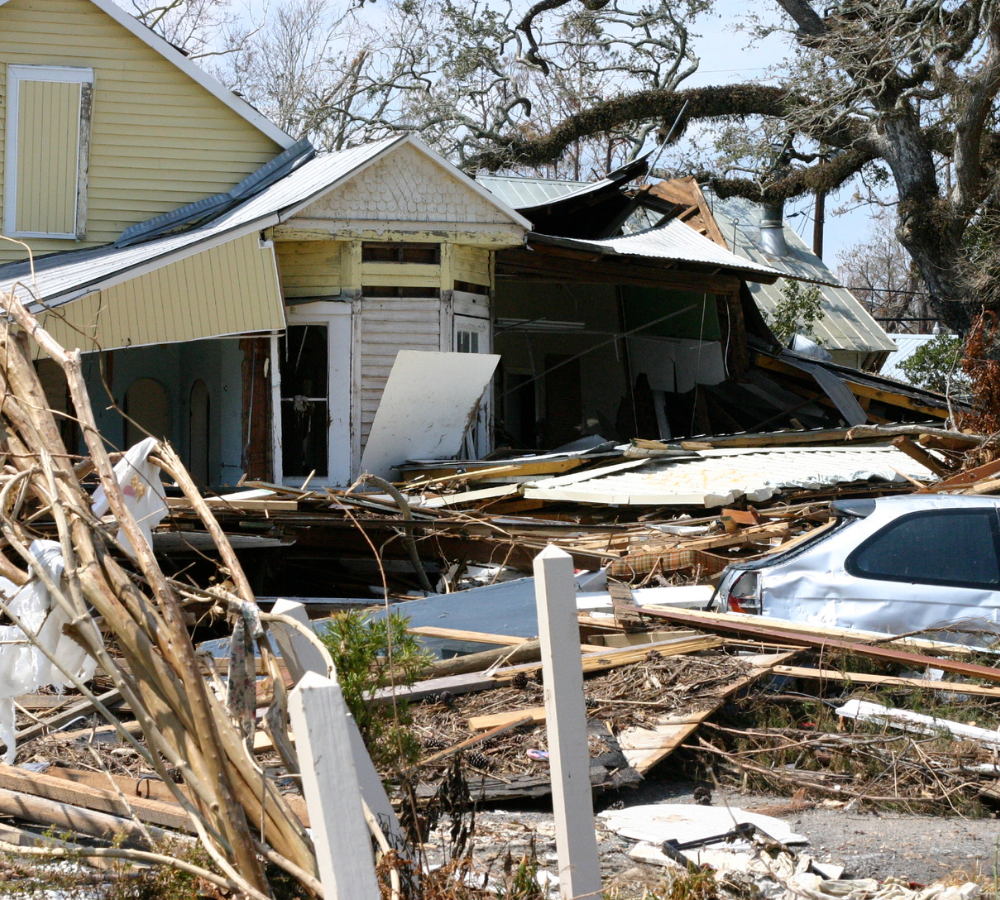 Wrecked house and car due to a hurricane.