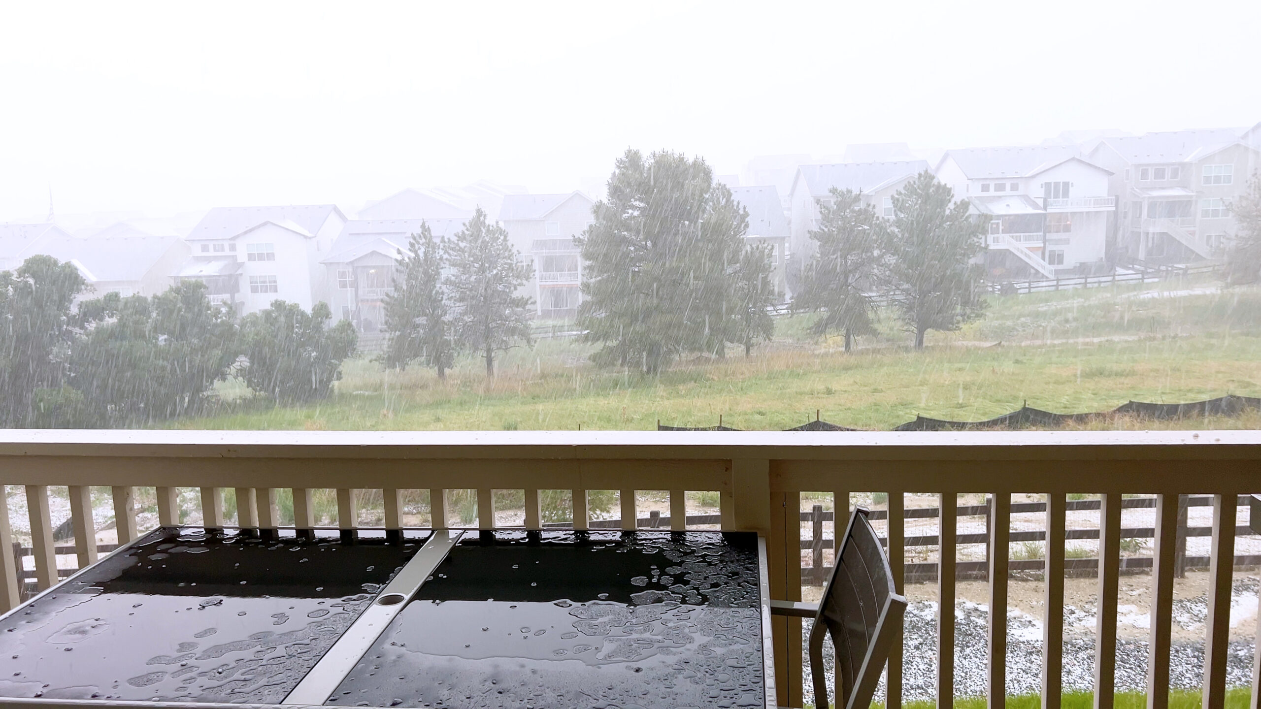 Hailstorm on Wooden Deck with Patio Furniture.